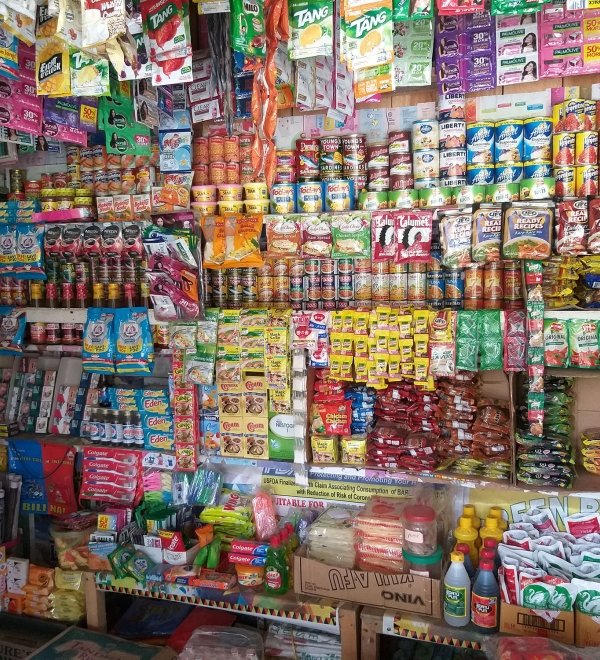 Image of convenience store wall covered in small plastic bags (sachets)