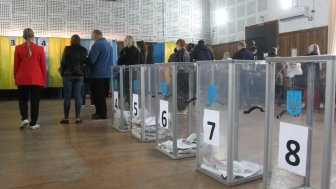 ODESSA, UKRAINE -25.10.2020 - Elections in Ukraine. Electoral platform for elections of local councilors during the COVID-19 coronavirus pandemic. People wearing masks and gloves with voting ballots