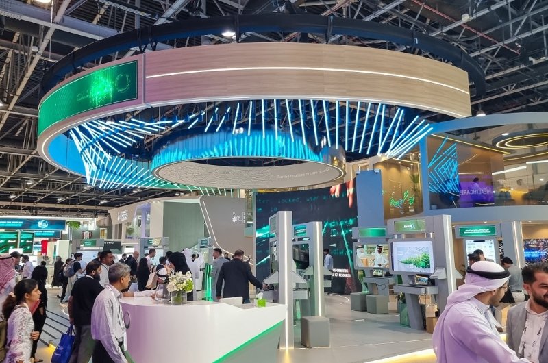 Visitors walking through DEWA Dubai Electricity and water Authority pavilion at 43rd GITEX Global 2023, largest tech and startup event in the world in Dubai, United Arab Emirates - O