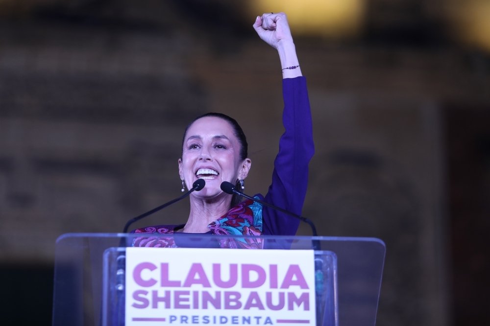 Claudia Sheinbaum with arm raised