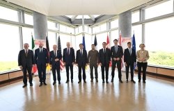 A group of world leaders posing in front of their respective flags at the G7 Summit in Hiroshima.