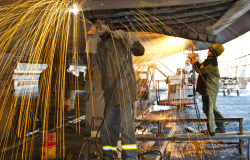 Welders working on a ship in dry dock