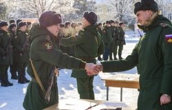 young soldier shakes hand of military recruitment officer